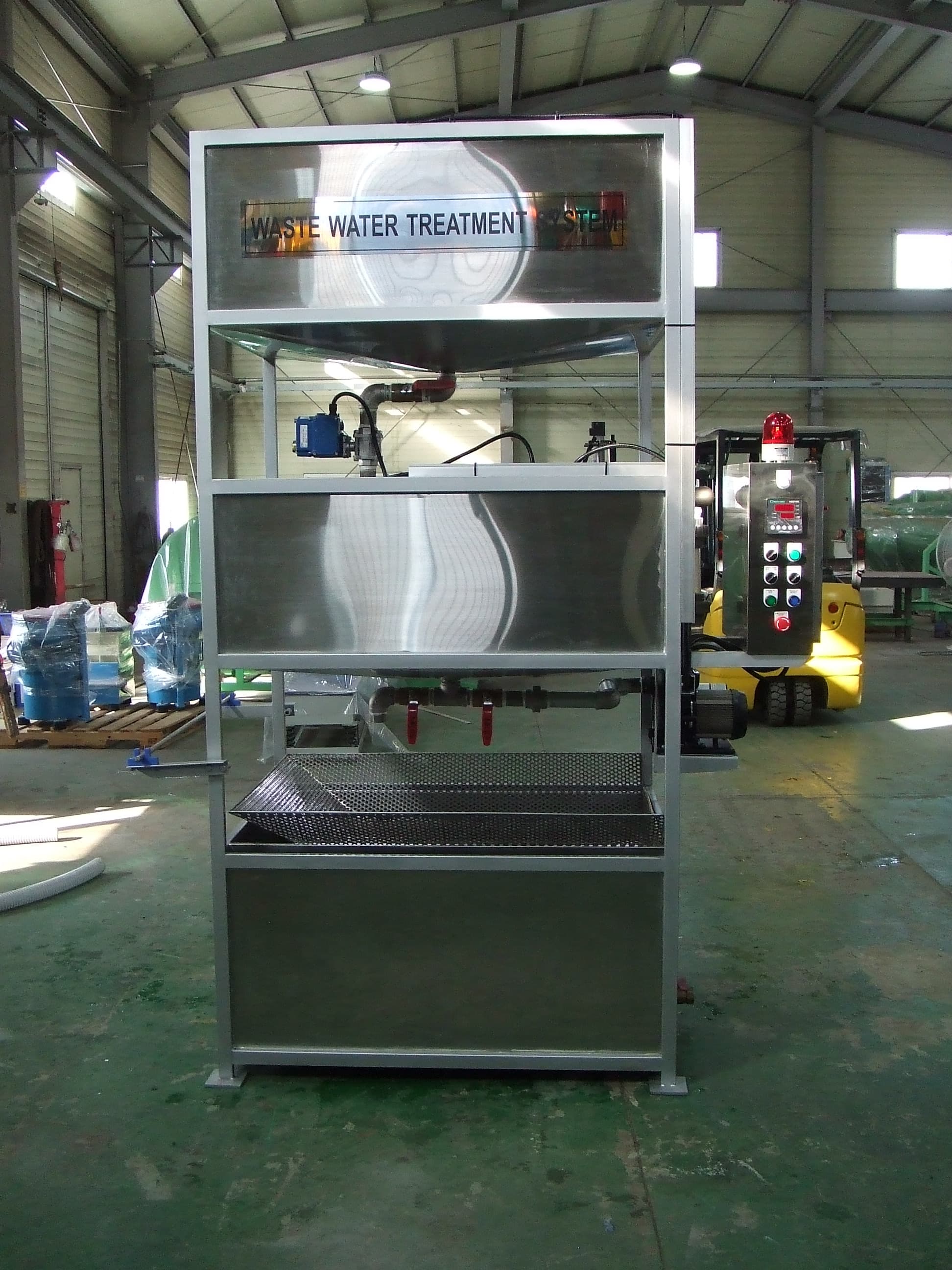 Actual WW 200 wastewater recycling system with stacked stainless steel tanks, filter tray, and control panel