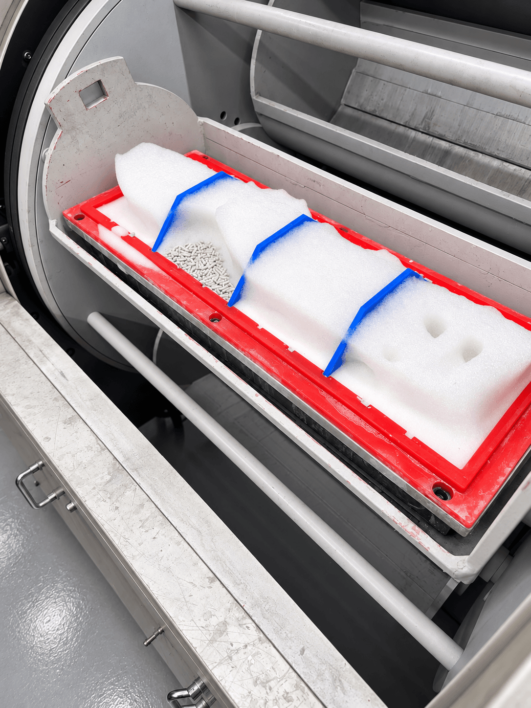 Close-up of the custom 18-inch barrel with red rim, three blue dividers, foam and finishing media