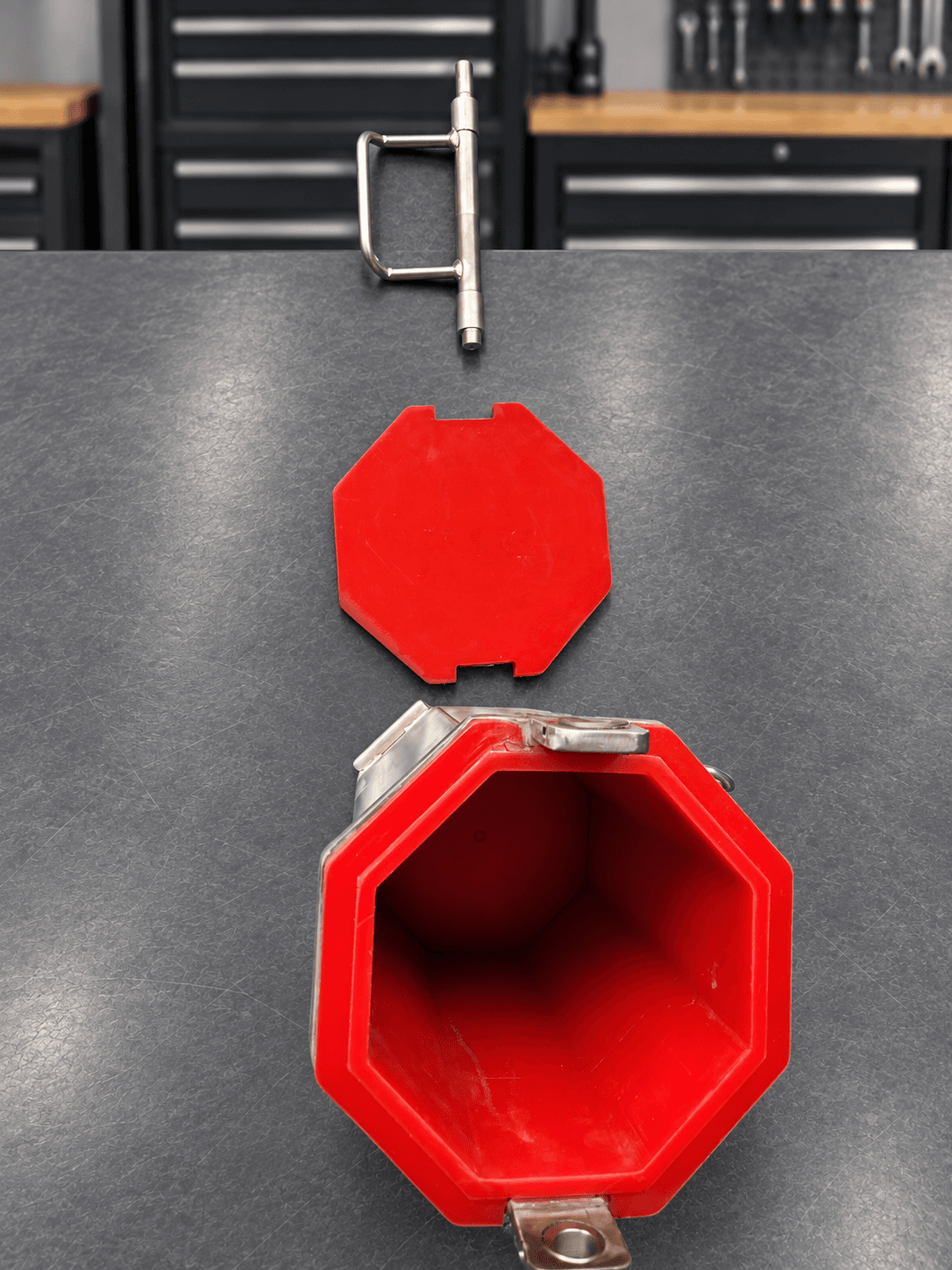 Overhead view into red replaceable polyurethane-lined quarter-cubic-foot barrel with lid and locking handle