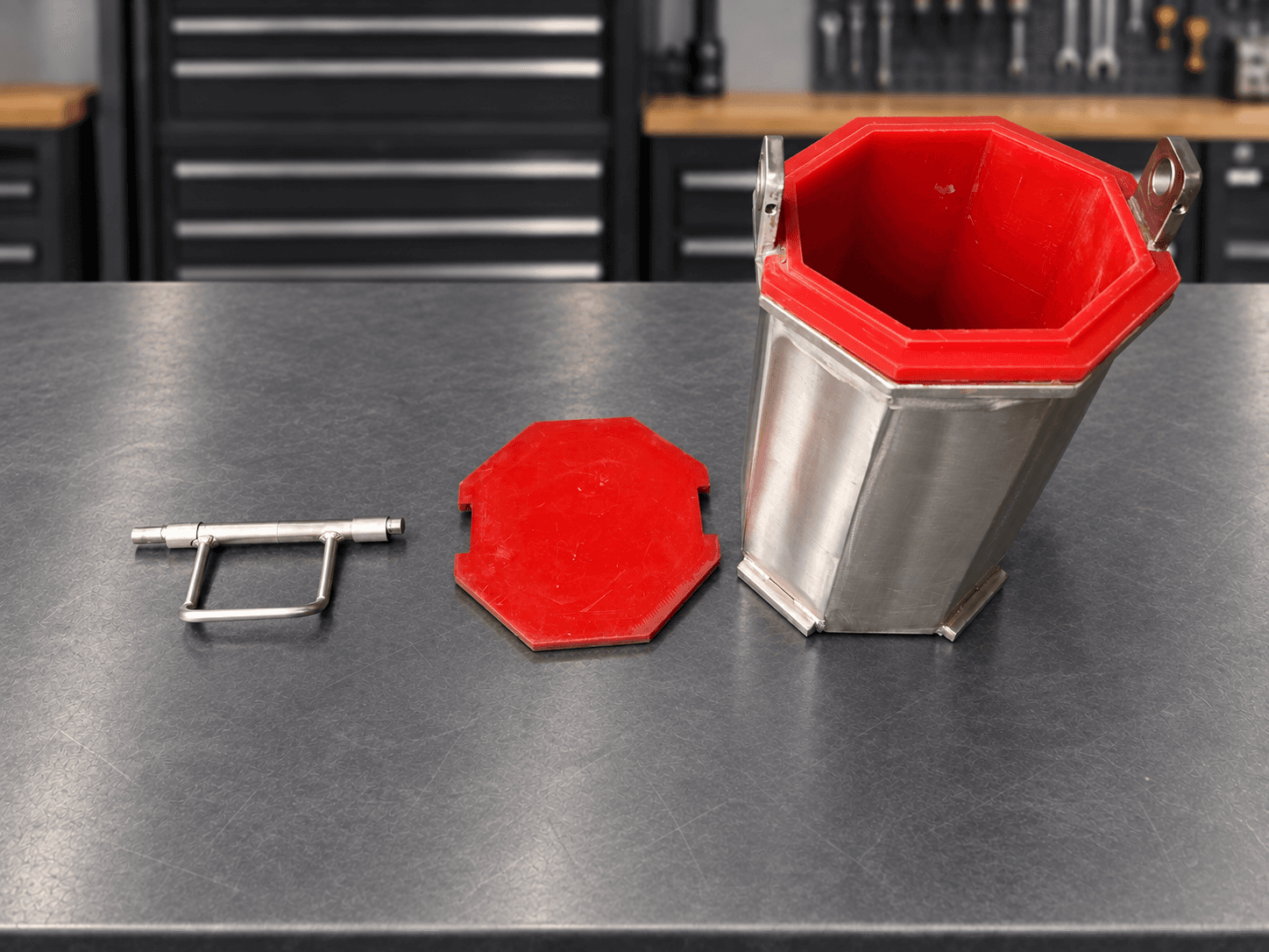 Open quarter-cubic-foot barrel with red polyurethane liner, detached lid and locking handle